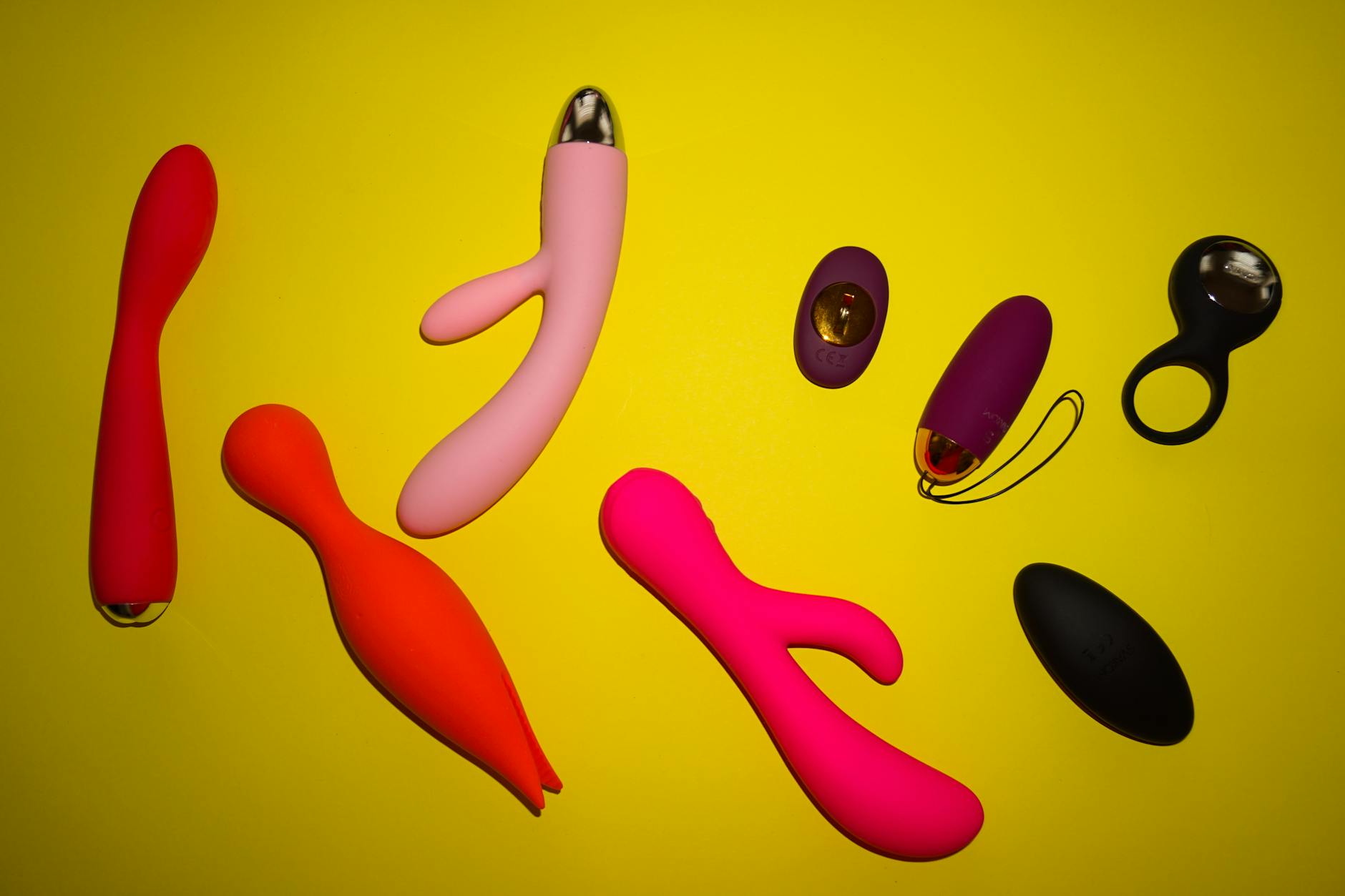 Colorful lemon clitoral vibrators and adult toys arranged on a bright surface