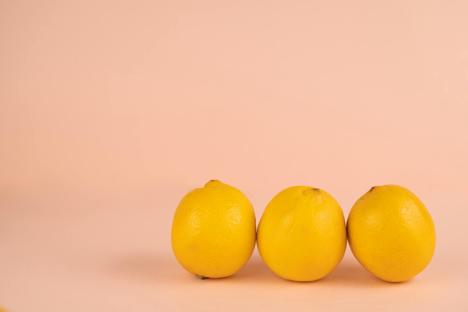 Woman holding a fresh lemon, exploring sensory pleasure and wellness